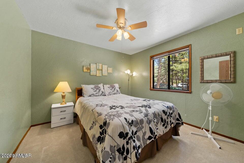 5801 Apache Trail Pinetop, AZ 85935 - Photo 25 of 39 a bedroom with a bed and a window
