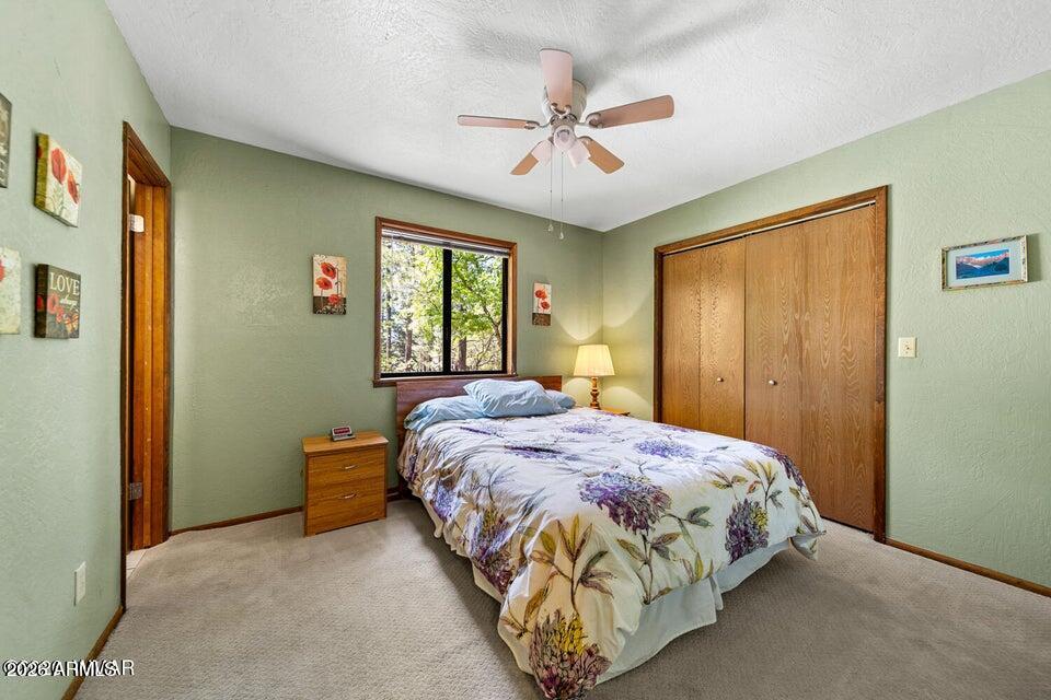 5801 Apache Trail Pinetop, AZ 85935 - Photo 27 of 39 a bedroom with a bed and window