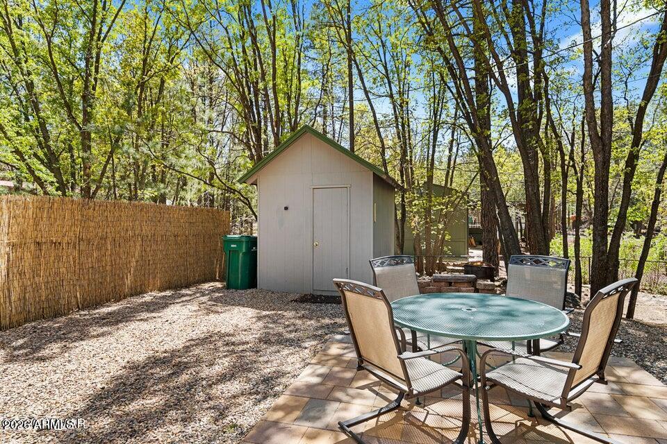 5801 Apache Trail Pinetop, AZ 85935 - Photo 7 of 39 a backyard of a house with table and chairs