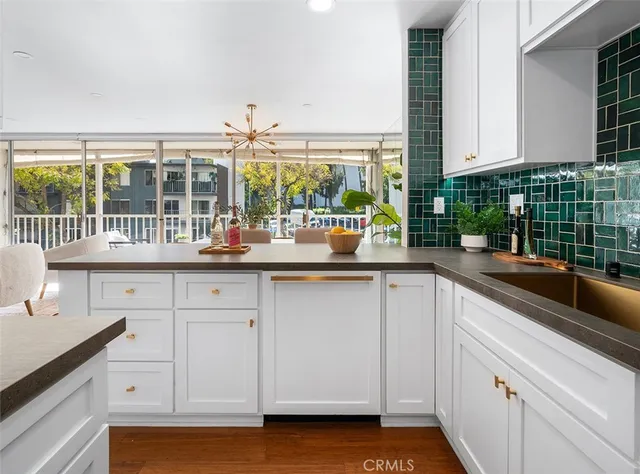 a kitchen with a sink and white cabinets