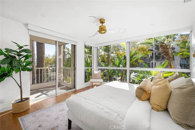 a bedroom with furniture and large windows