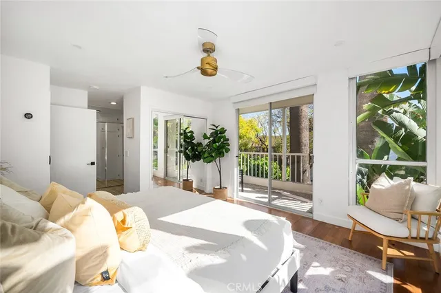 a bedroom with a bed and large window