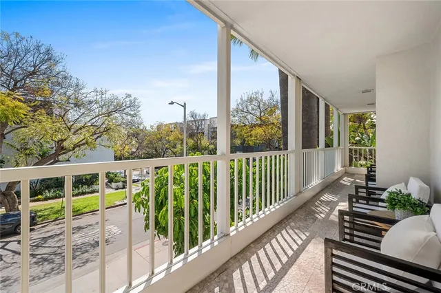 a balcony of a house with wooden floor and outdoor space