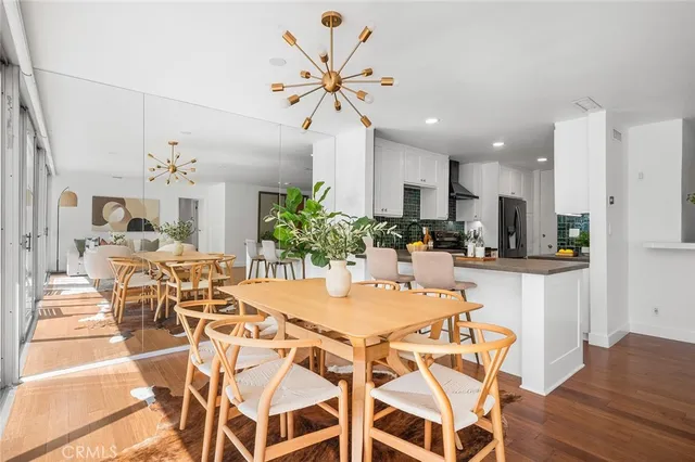 a view of a dining room with furniture and a chandelier