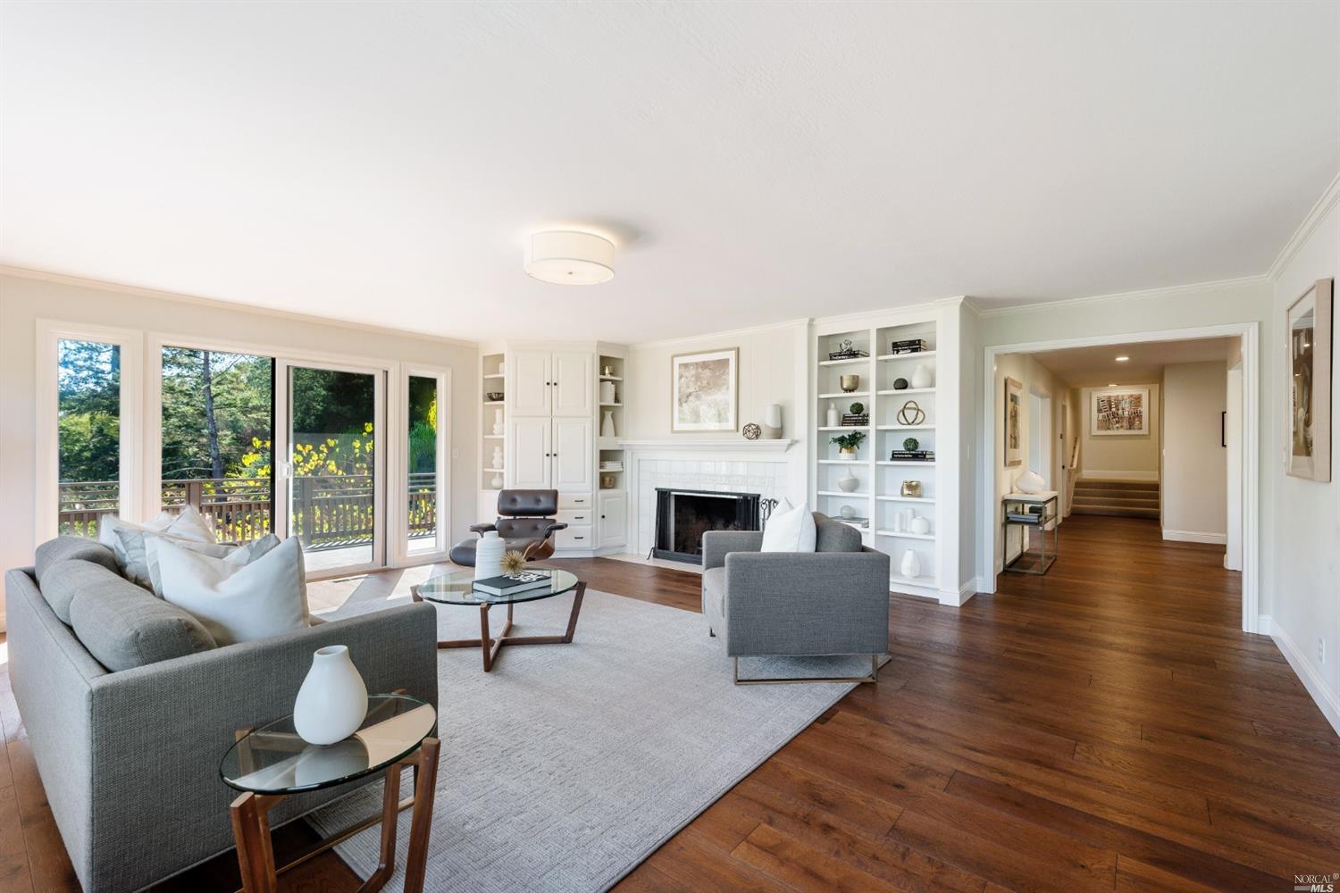 a living room with fireplace furniture and a wooden floor