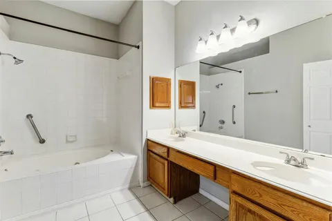 a bathroom with a tub sink and mirror