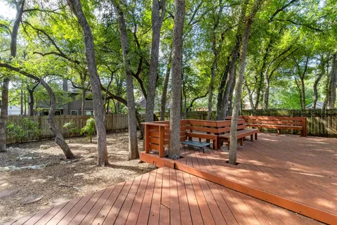 a backyard of a house with barbeque oven table and chairs