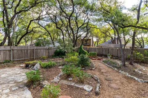 a view of garden with wooden fence