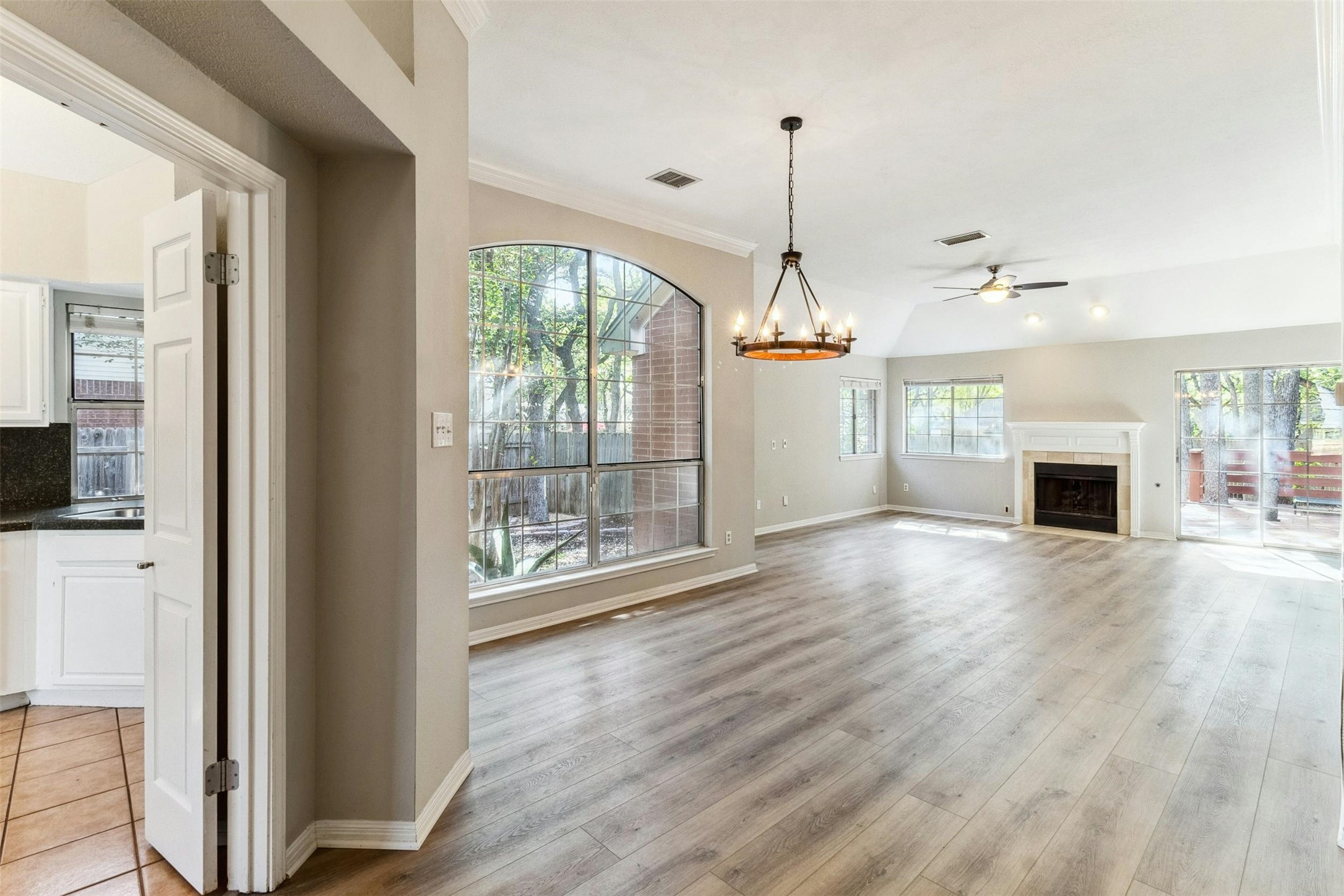 5905 Shanghai Pierce Road Austin, TX 78749 - Photo 3 of 21 a view of empty room with wooden floor and fireplace