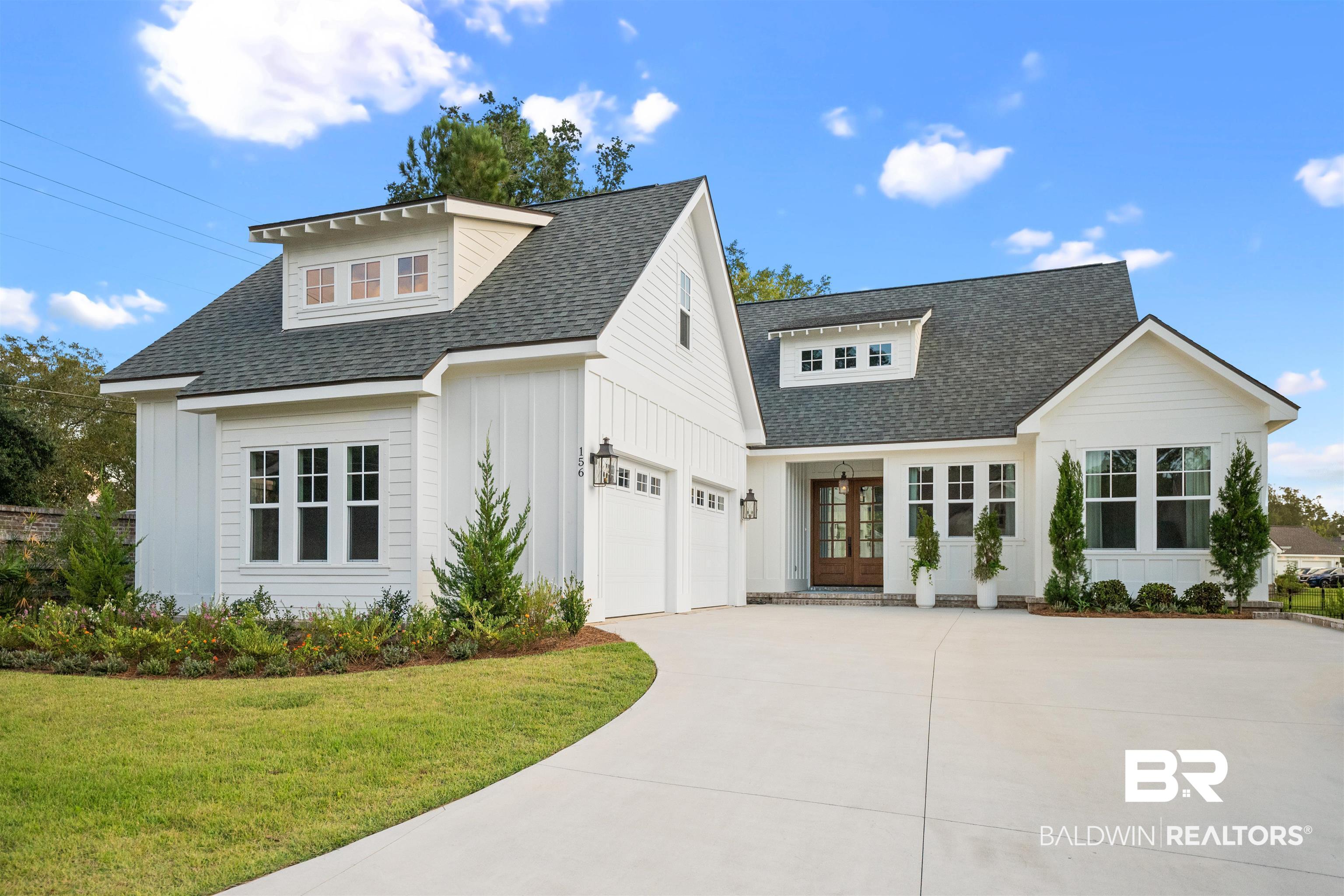 156 Hyacinth Street Fairhope, AL 36532 - Photo 1 of 61 Modern inspired farmhouse with roof with shingles, a garage, and board and batten siding