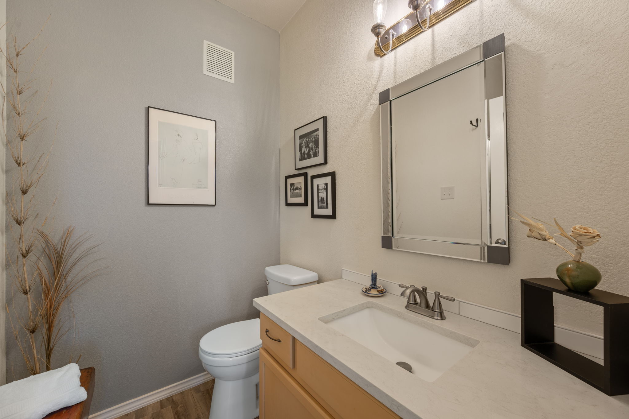 12401 Los Indios Trail, Unit 32 Austin, TX 78729 - Photo 24 of 39 A compact and functional powder room with a vanity and modern fixtures.