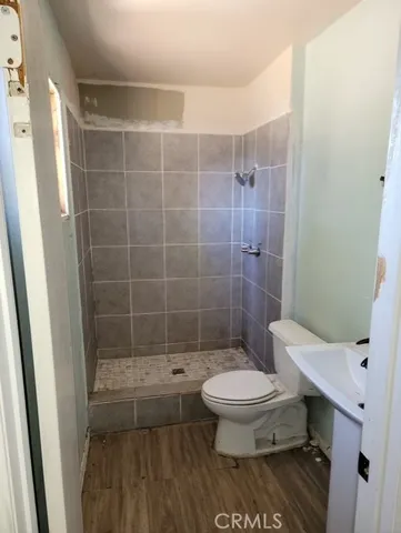 a bathroom with a toilet a sink and shower