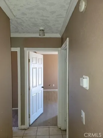 a view of a hallway with wooden shelves