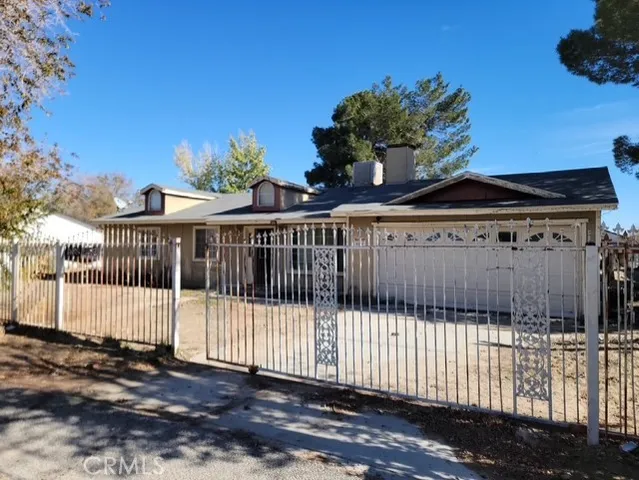 a view of a house with a wooden fence