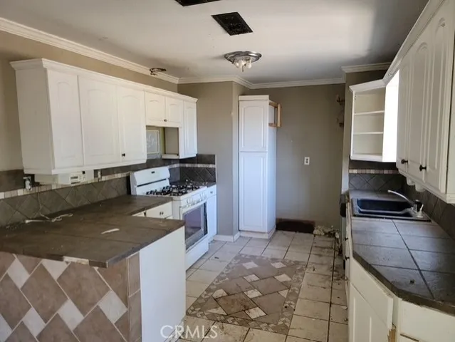 a kitchen with a stove a sink and a refrigerator