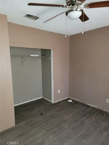 a view of an empty room and wooden floor