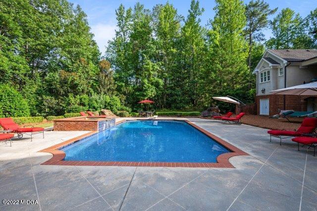 7959 Whittle Road Macon, GA 31220 - Photo 11 of 49 a swimming pool with outdoor seating and yard
