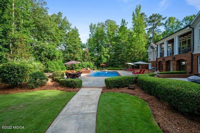 7959 Whittle Road Macon, GA 31220 - Photo 13 of 49 a front view of a house with a yard and a garden