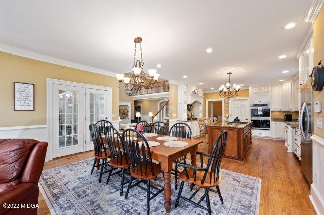 7959 Whittle Road Macon, GA 31220 - Photo 18 of 49 a view of a dining room with furniture a chandelier and wooden floor