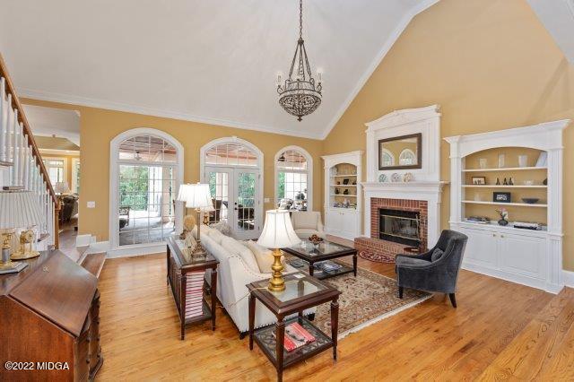 7959 Whittle Road Macon, GA 31220 - Photo 20 of 49 a living room with furniture a fireplace and wooden floor
