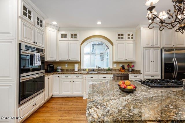 7959 Whittle Road Macon, GA 31220 - Photo 23 of 49 a kitchen with stainless steel appliances granite countertop a stove a sink and a microwave