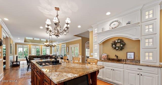 7959 Whittle Road Macon, GA 31220 - Photo 25 of 49 a kitchen with a stove a sink a kitchen island with windows and chairs