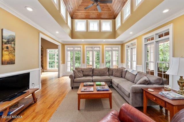 7959 Whittle Road Macon, GA 31220 - Photo 26 of 49 a living room with furniture a flat screen tv and a floor to ceiling window
