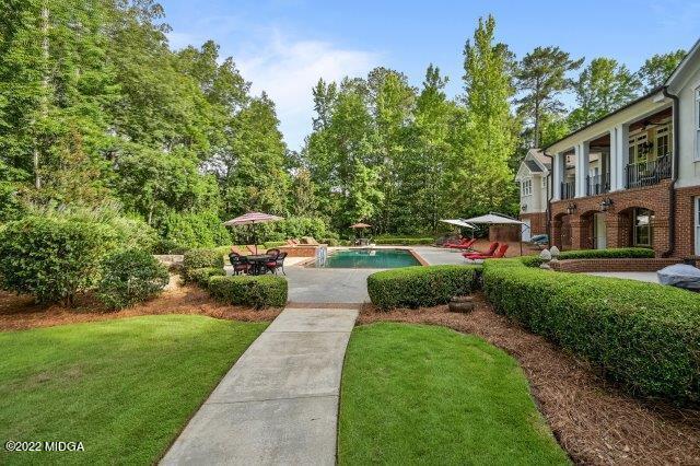 7959 Whittle Road Macon, GA 31220 - Photo 8 of 49 a front view of a house with a garden and trees