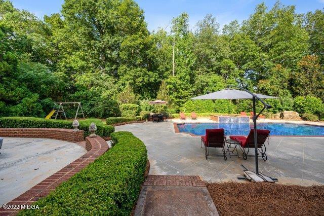 7959 Whittle Road Macon, GA 31220 - Photo 9 of 49 an outdoor space with furniture and umbrella
