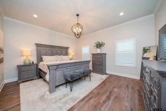 a bedroom with bed and wooden floor