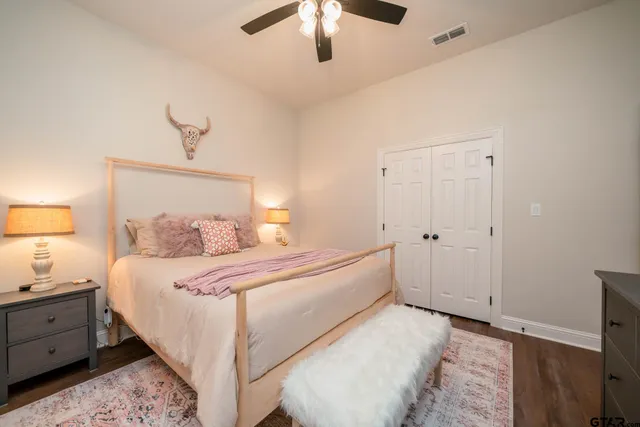 a bedroom with a large bed and a chandelier