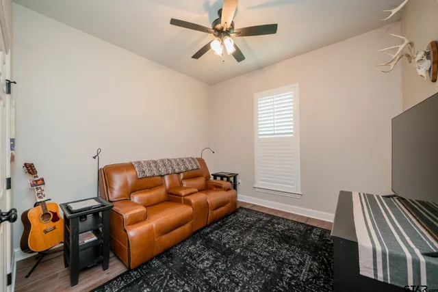 a blue couch sitting in a room next to a window
