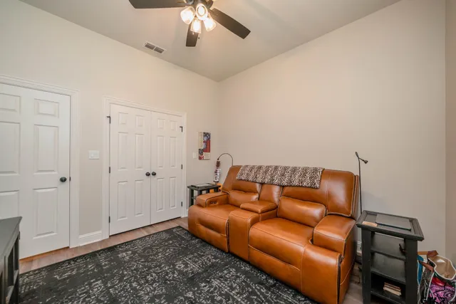 a blue couch sitting next to a empty room