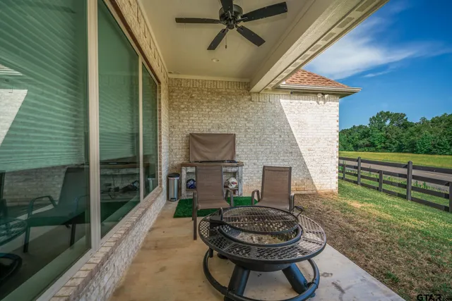 a backyard of a house with fire pit and outdoor seating