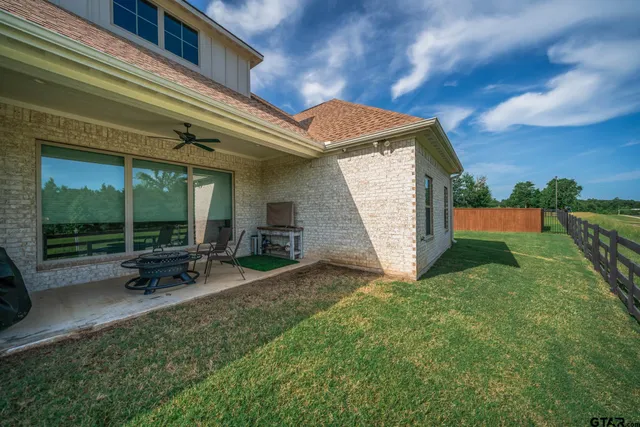 a view of a house with backyard porch and sitting area