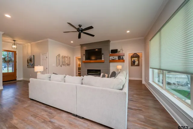 a living room with furniture a fireplace and a flat screen tv
