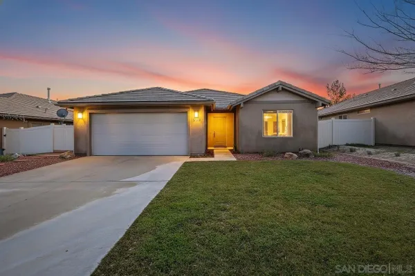 a front view of house with yard and outdoor seating