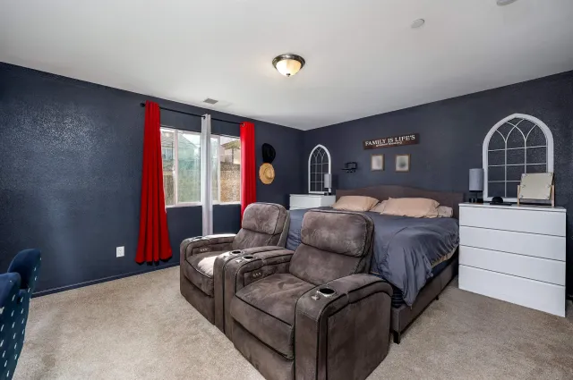 a bedroom with a bed and glass window