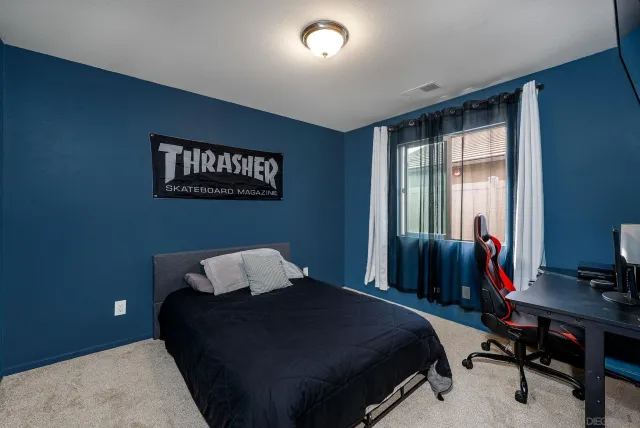 a bedroom with a bed and a desk