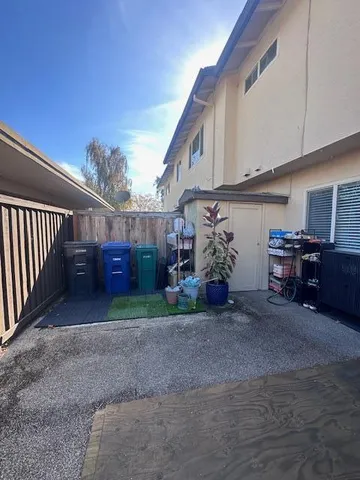 a view of a porch with furniture and a yard