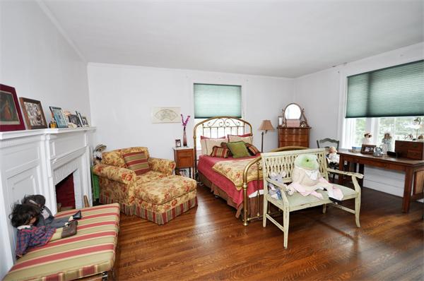 199 Dean Road Brookline, MA 02445 - Photo 8 of 15 a bedroom with two beds and a fireplace