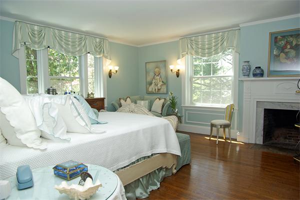 199 Dean Road Brookline, MA 02445 - Photo 9 of 15 a bedroom with a bed a large window and wooden floor
