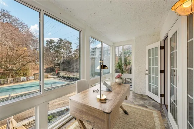 a living room with furniture and a floor to ceiling window
