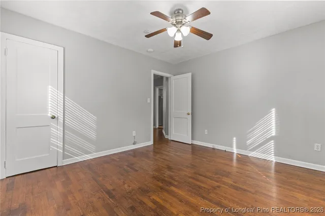 a view of an empty room with wooden floor
