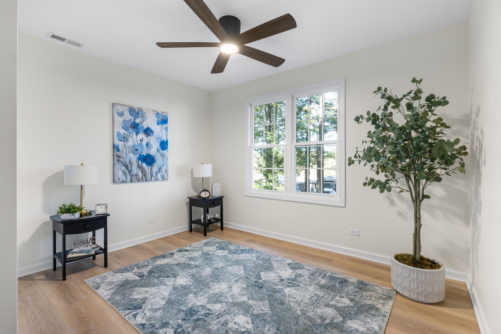 275 Indian Trail Lake In The Hills, IL 60156 - Photo 16 of 25 a view of a livingroom with a potted plant a ceiling fan and a window