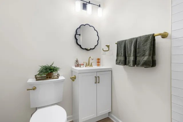 a bathroom with a toilet a sink and a mirror
