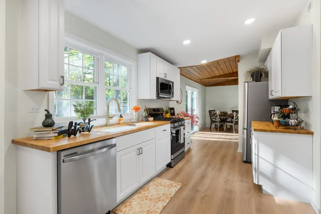 a kitchen with sink a stove and cabinets