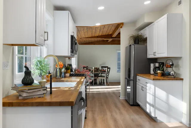 a kitchen with stainless steel appliances granite countertop a refrigerator and a sink