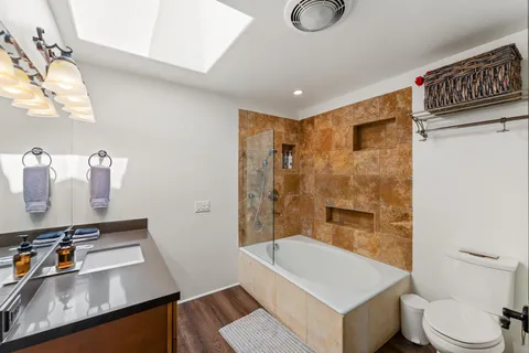 a large white kitchen with sink a stove and a window