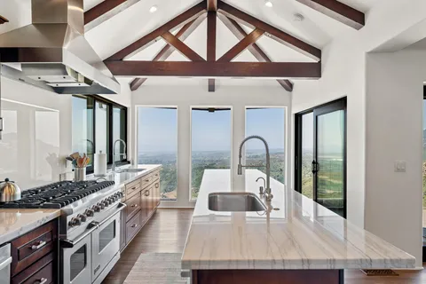 a kitchen with a stove a sink and a refrigerator